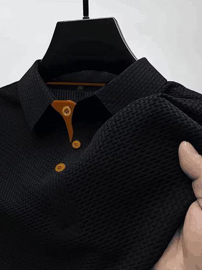 Men's waffle knit polo top in black, close-up of the collar, button placket and waffle texture