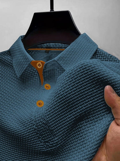 Men's waffle knit polo top in blue, close-up of the collar, button placket and waffle texture