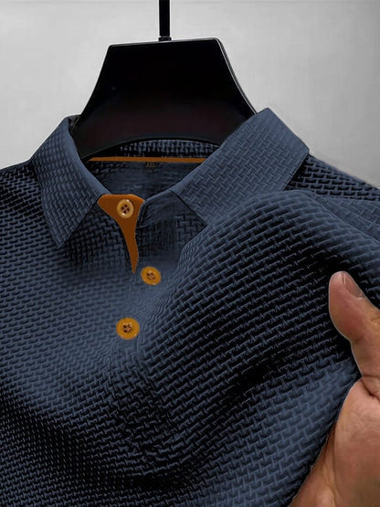 Men's waffle knit polo top in dark blue, close-up of the collar, button placket and waffle texture