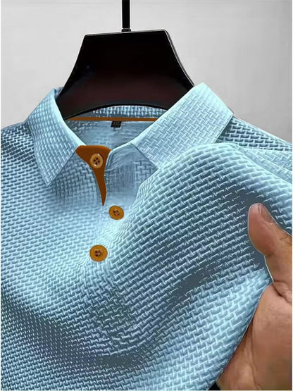 Men's waffle knit polo top in light blue, close-up of the collar, button placket and waffle texture