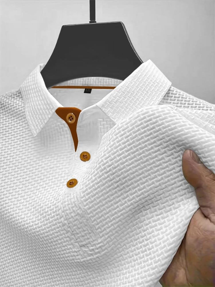 Men's waffle knit polo top in white, close-up of the collar, button placket and waffle texture