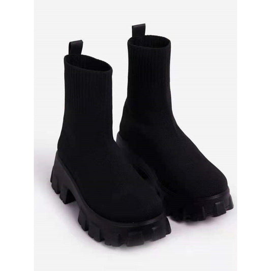 Women's black chunky sole ankle boots with lugged tread